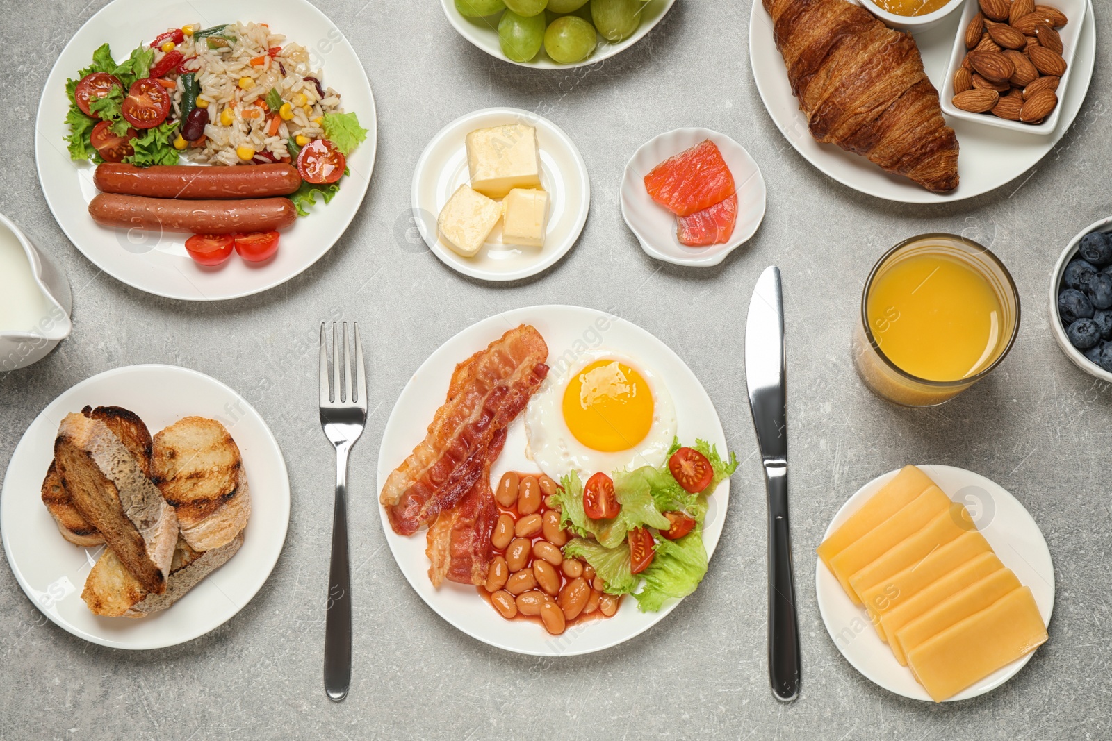 Photo of Different dishes and juice on light grey table, flat lay. Buffet service