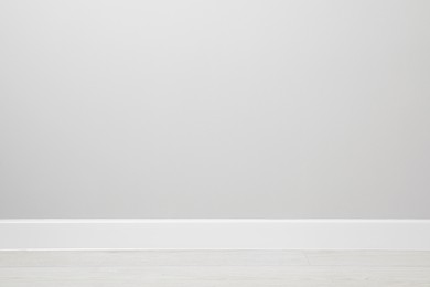 White plinth on laminated floor near wall indoors