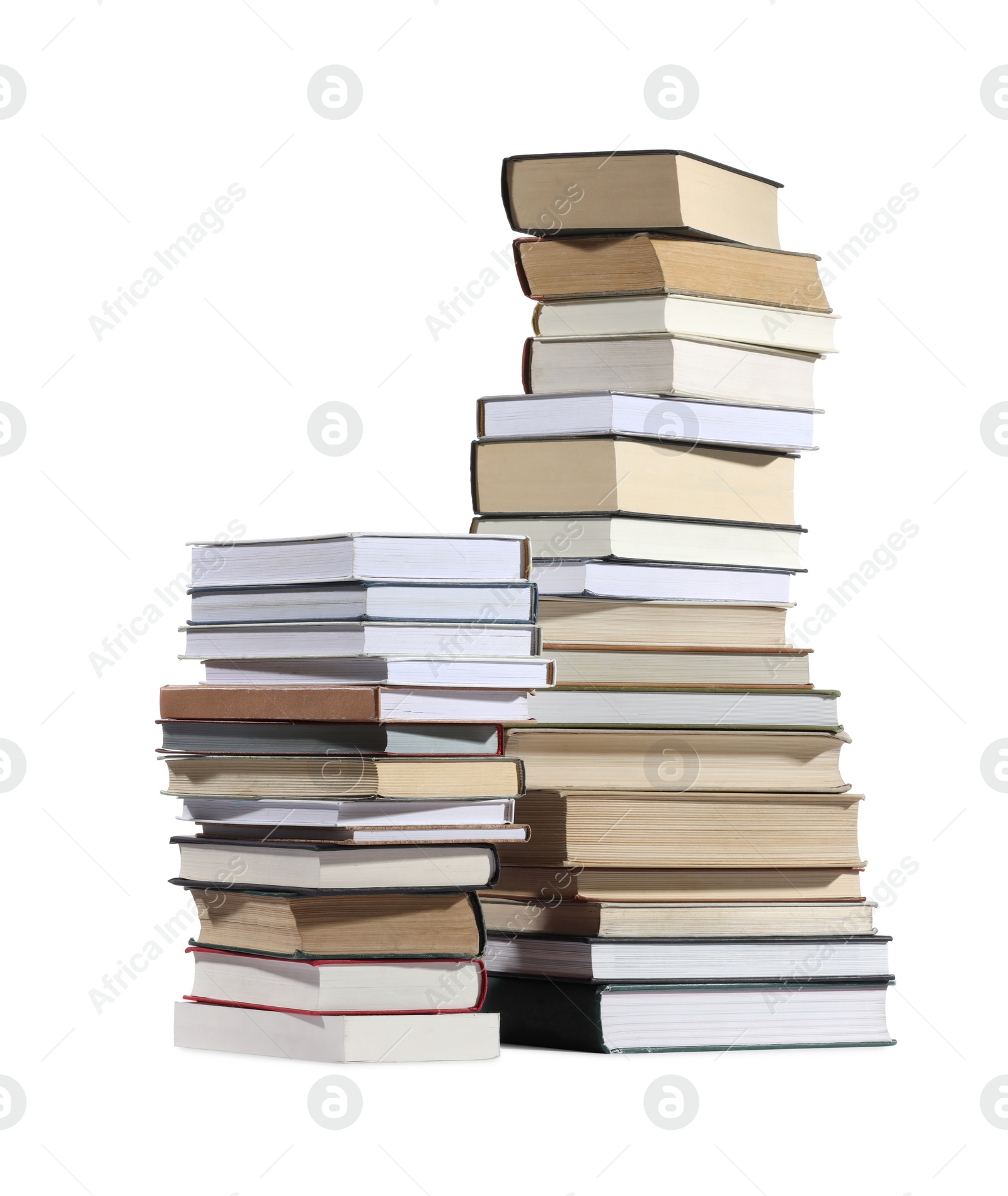 Photo of Stacks of many different books isolated on white