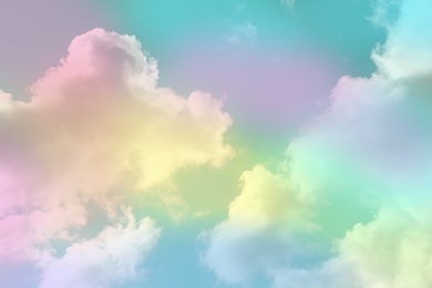 Image of Fantasy world. Picturesque view of beautiful magic sky with fluffy clouds, toned in pastel rainbow or unicorn colors