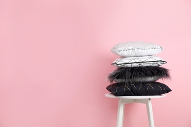 Photo of Chair with many different pillows and space for text on color background