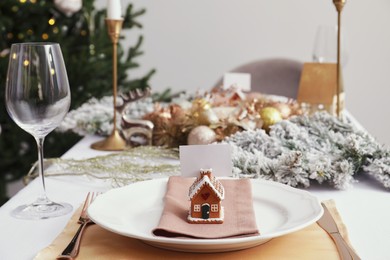 Luxury festive place setting with blank card and beautiful decor for Christmas dinner on white table indoors