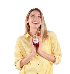 Young attractive woman eating tasty yogurt on white background