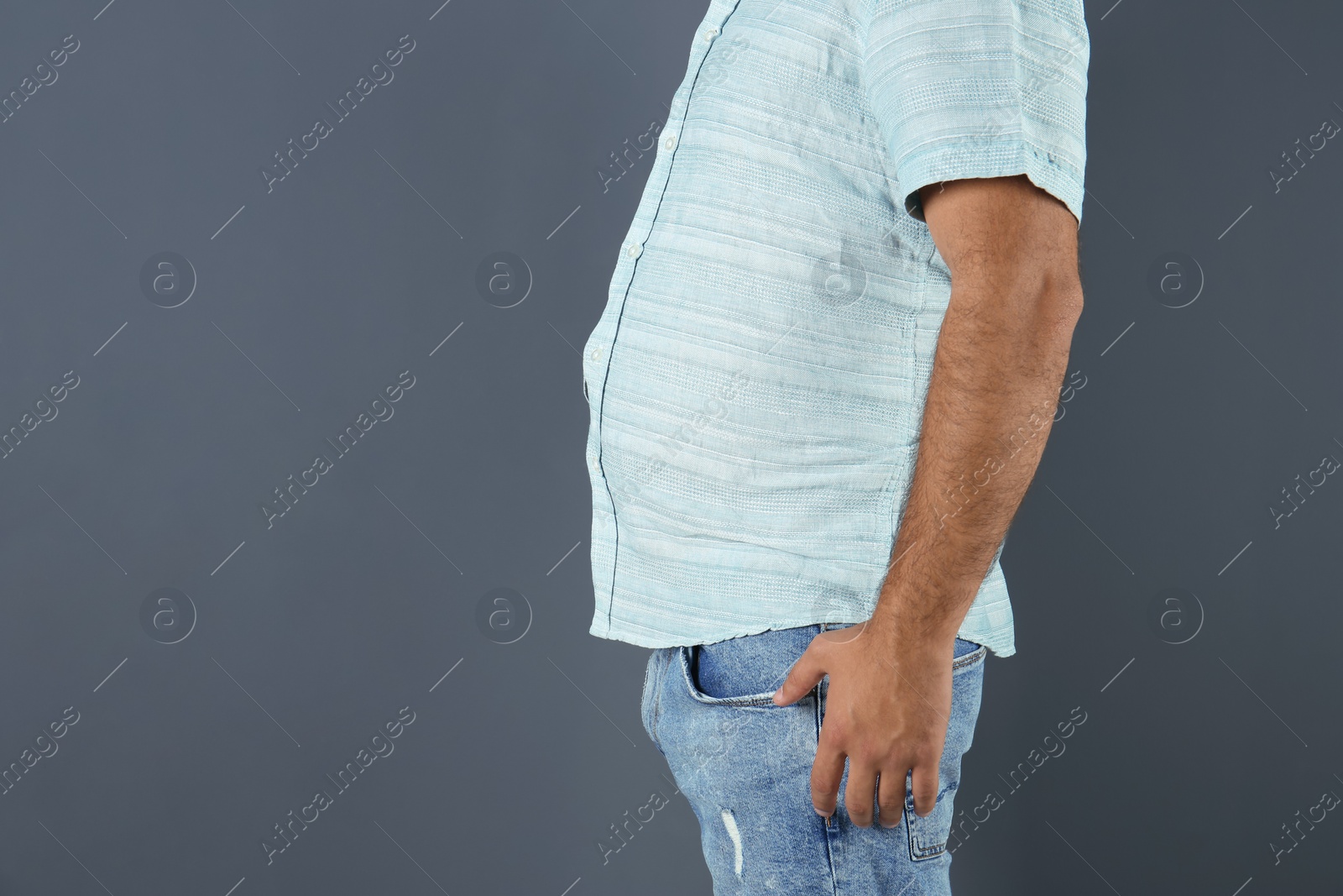 Photo of Overweight man on gray background, closeup view with space for text