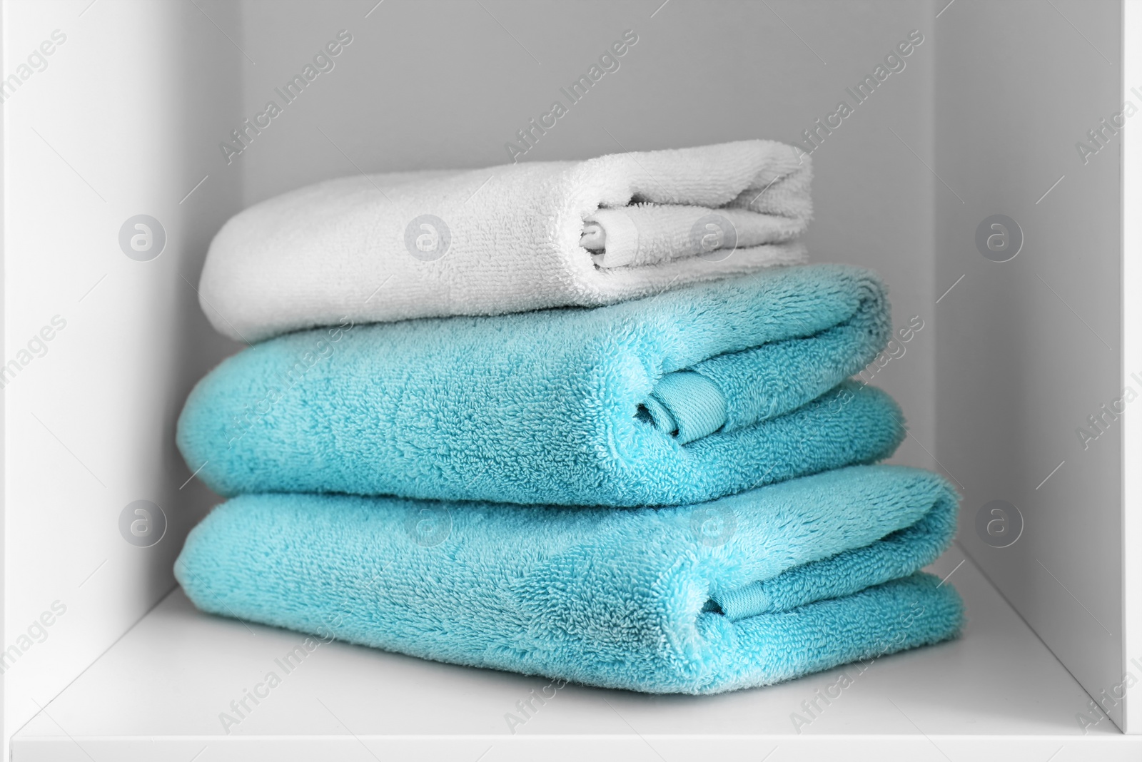 Photo of Stack of clean towels on shelf