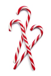 Sweet candy canes on white background, top view. Christmas treat 