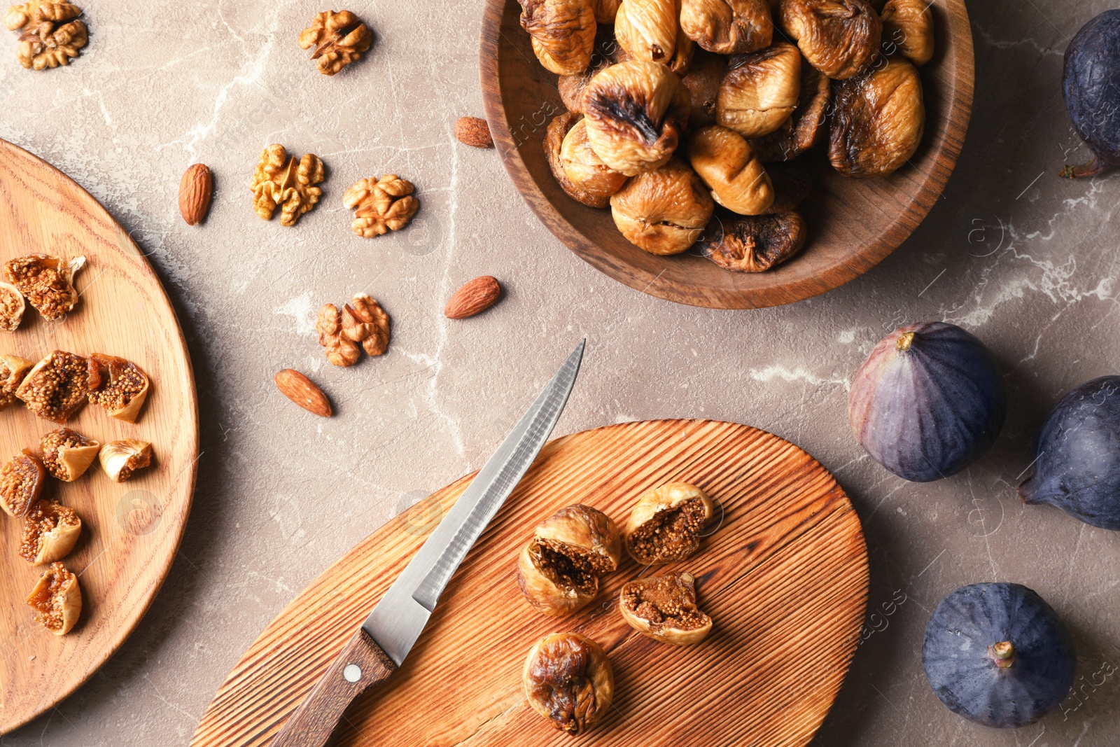 Photo of Flat lay composition with nuts, fresh and dried figs on grey background