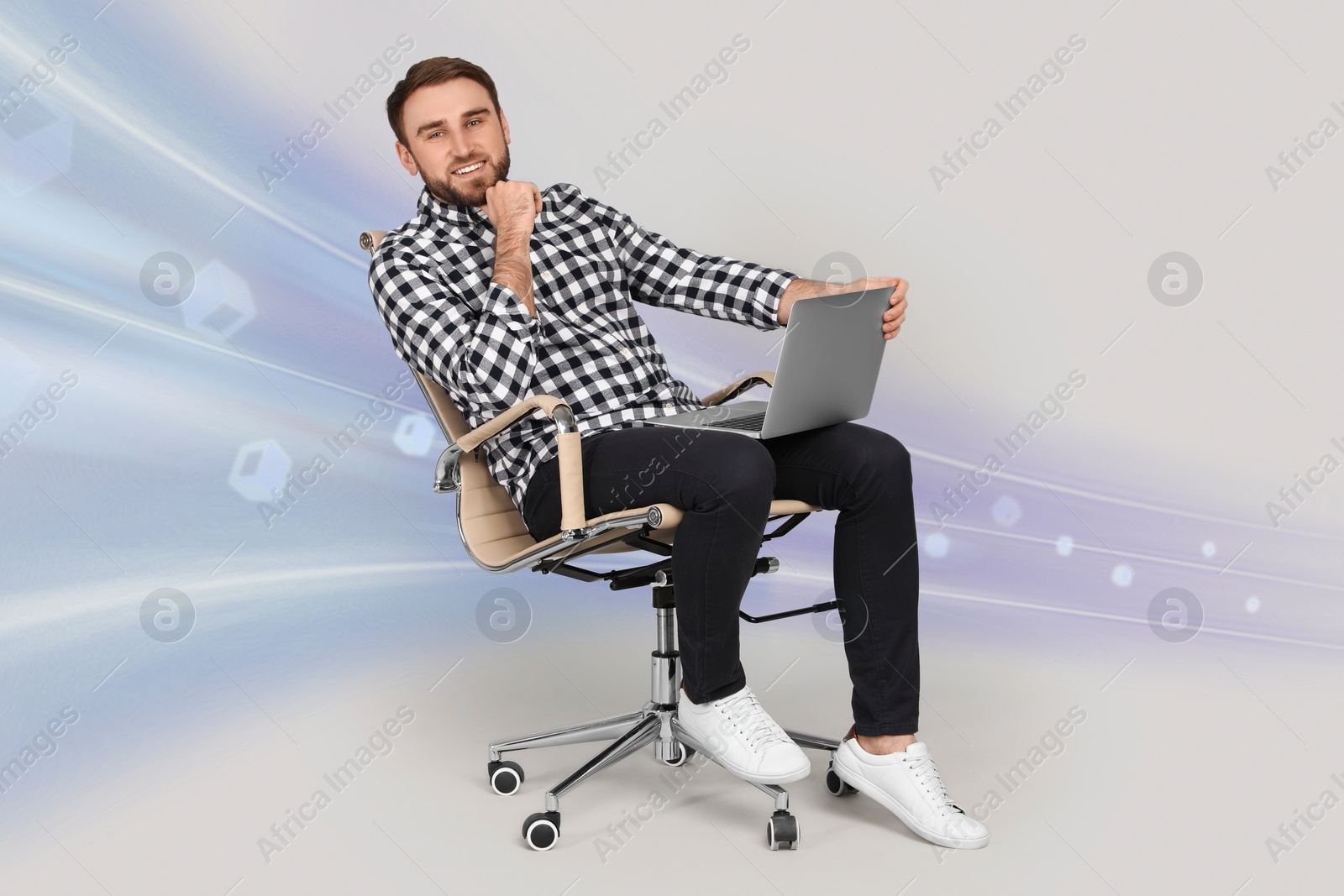 Image of Speed internet. Happy man with laptop sitting in office chair on light grey background. Motion blur effect symbolizing fast connection