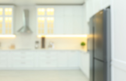 Photo of Blurred view of modern kitchen interior with stylish furniture