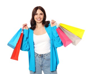 Beautiful young woman with paper shopping bags on white background