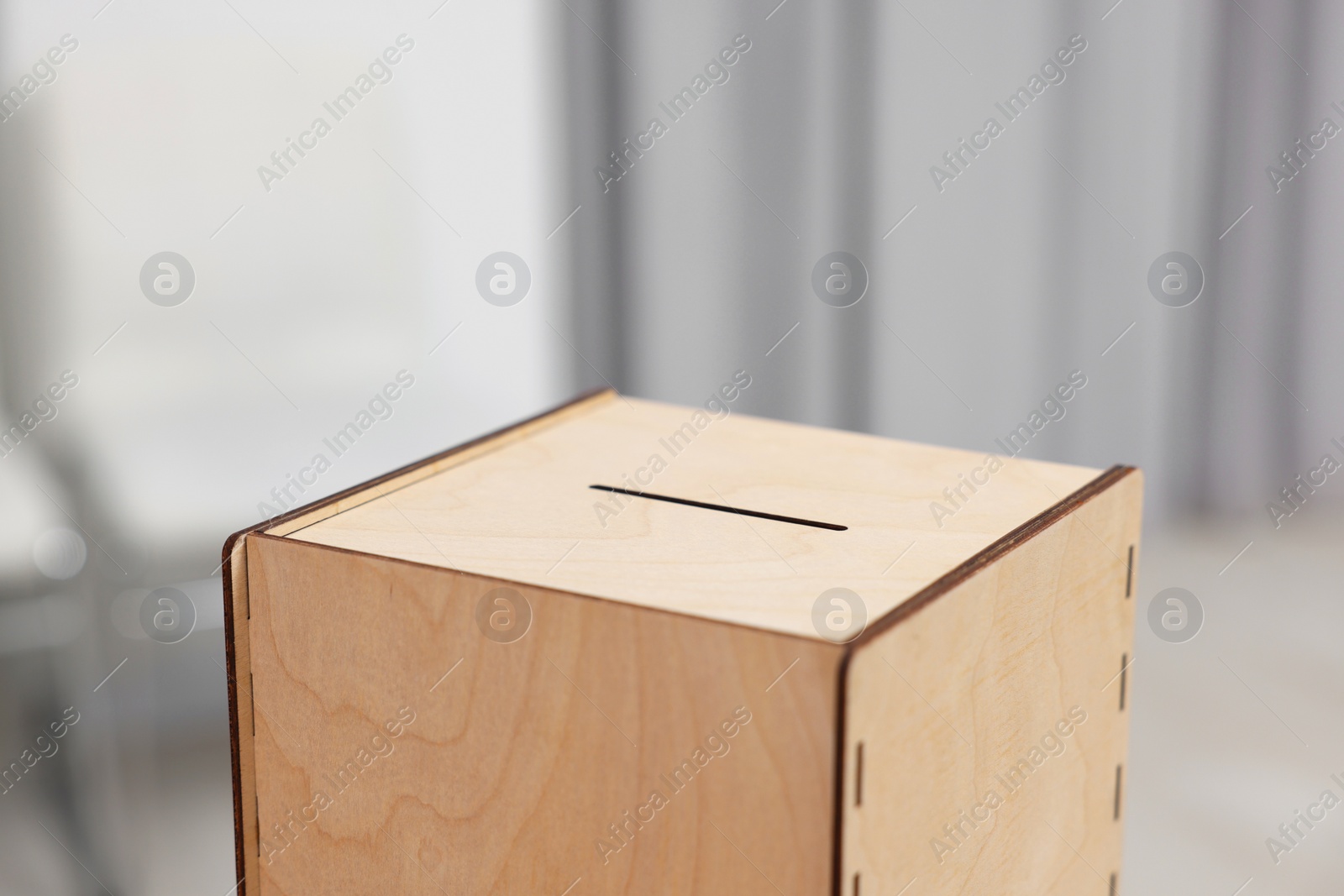 Photo of Wooden ballot box on blurred background, closeup