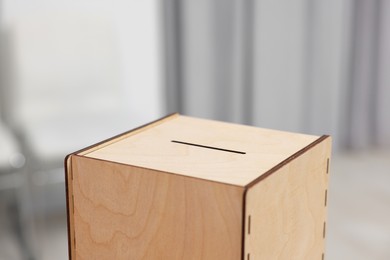 Photo of Wooden ballot box on blurred background, closeup