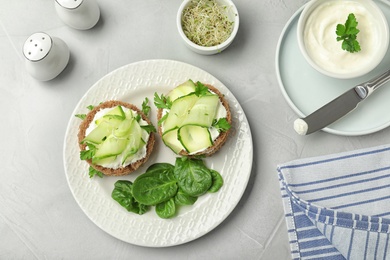 Flat lay composition with traditional English cucumber sandwiches on grey background