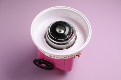 Photo of Portable candy cotton machine on violet background, above view