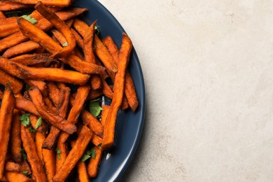 Photo of Delicious sweet potato fries served with sauce on light table, top view. Space for text