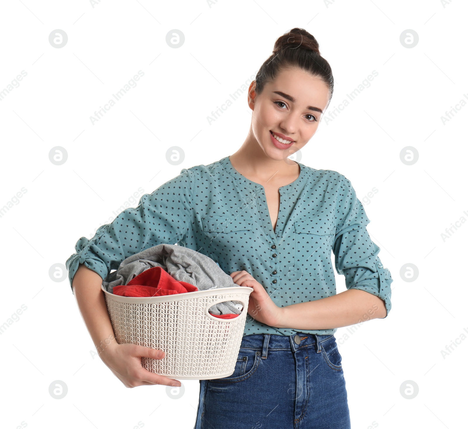 Photo of Happy young woman holding basket with laundry on white background