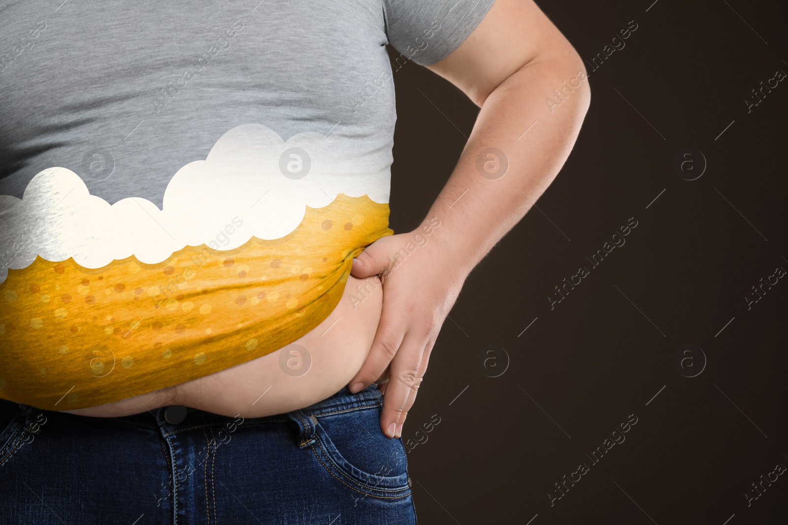Image of Beer belly problem. Overweight man on brown background, closeup