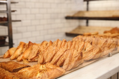 Fresh pastries on counter in bakery store. Space for text