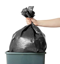 Photo of Woman holding trash bag full of garbage over bucket on white background, closeup
