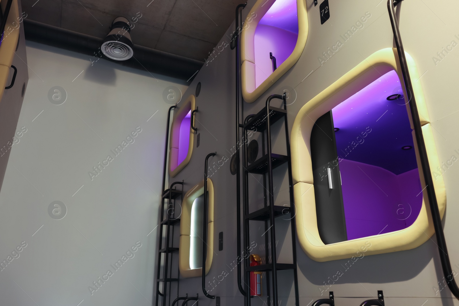 Photo of Capsules in modern pod hostel. Stylish interior