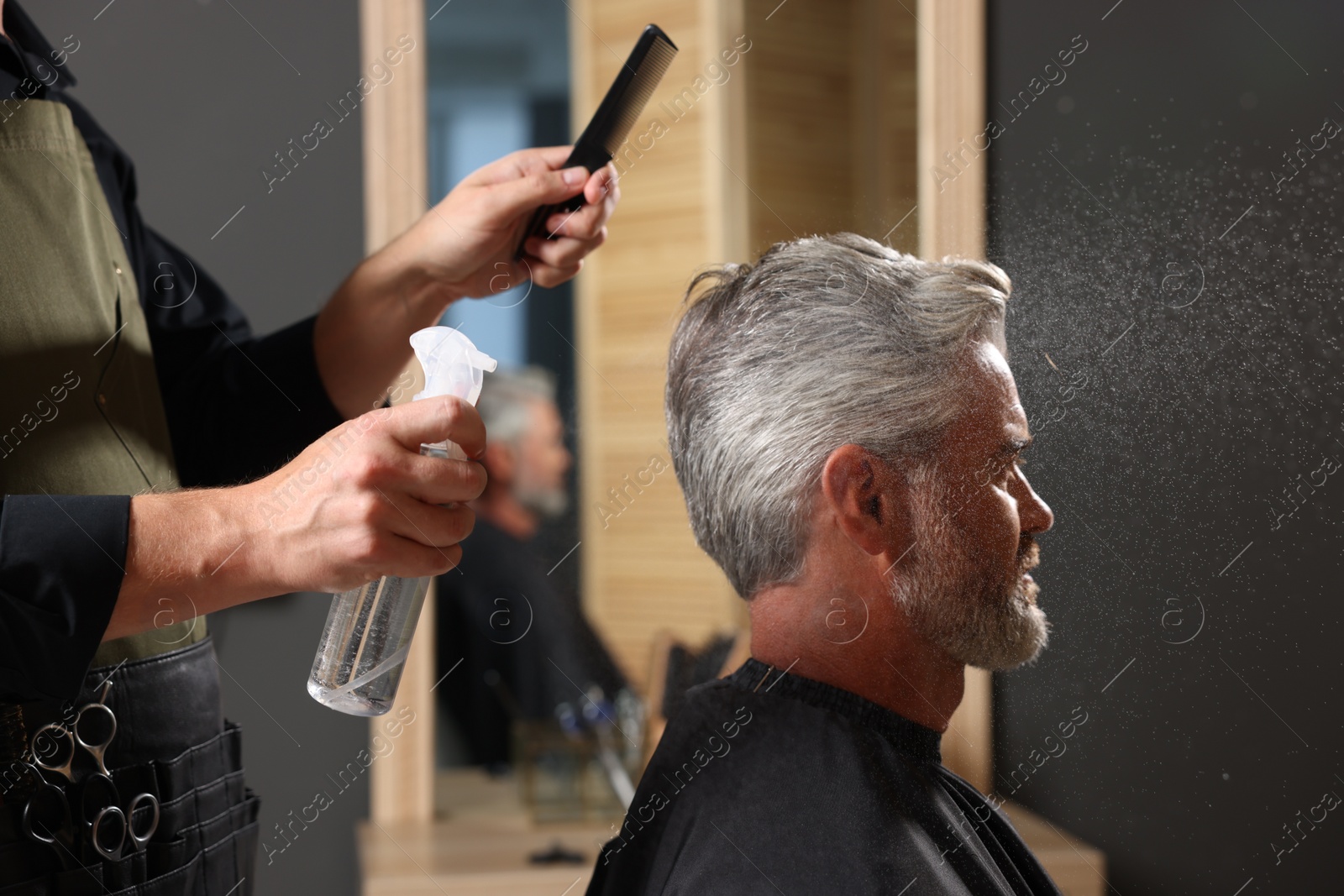 Photo of Hair styling. Professional hairdresser working with client in barbershop, closeup