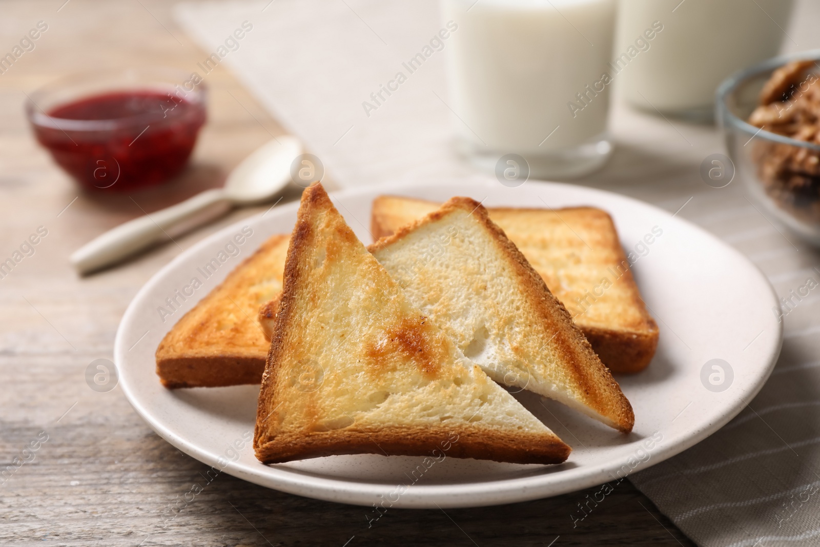 Photo of Tasty toasts served for breakfast on wooden table