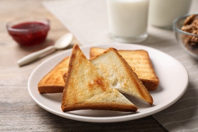 Tasty toasts served for breakfast on wooden table