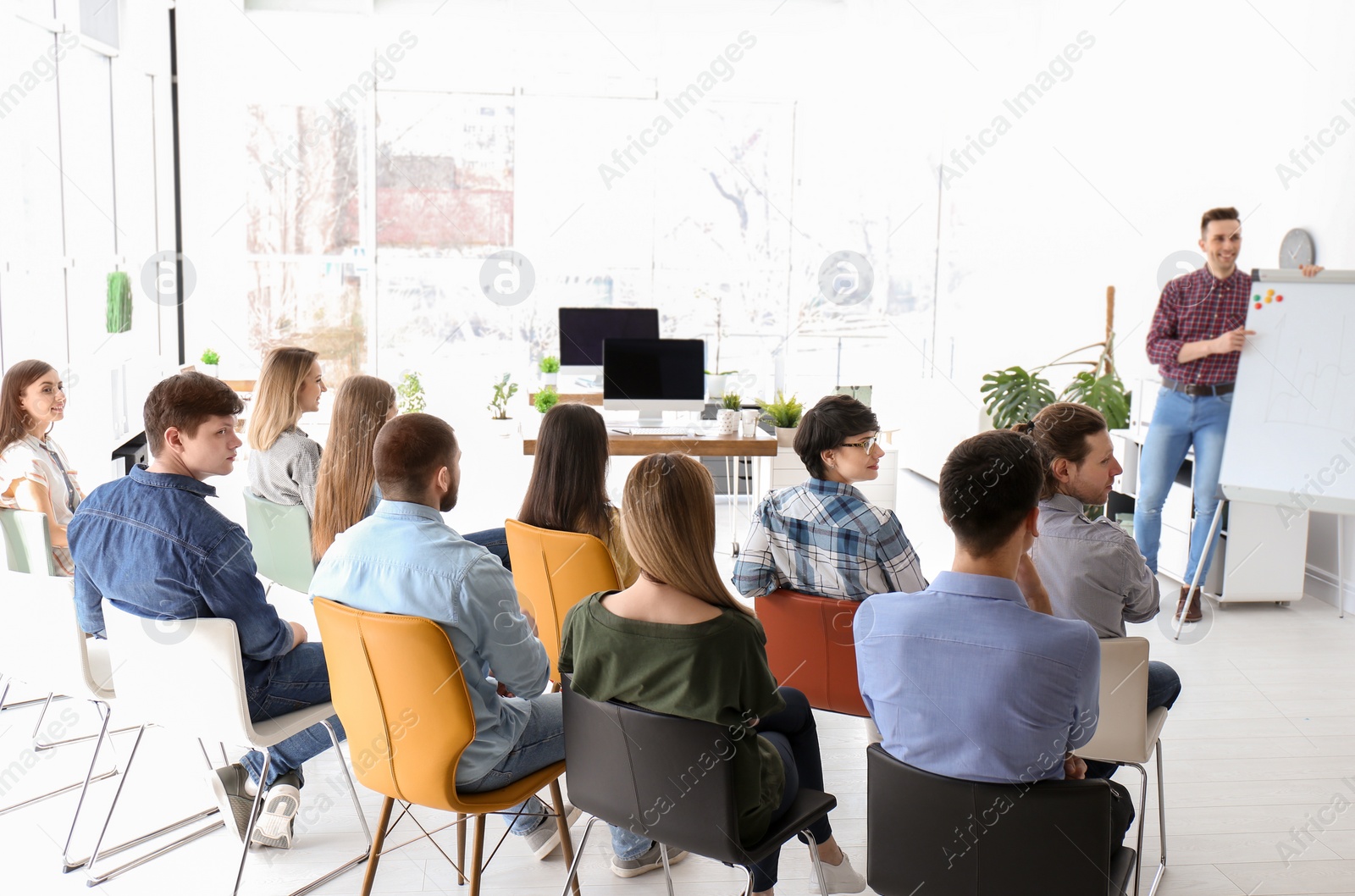 Photo of Male business trainer giving lecture in office