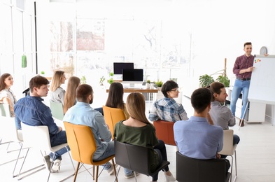 Photo of Male business trainer giving lecture in office