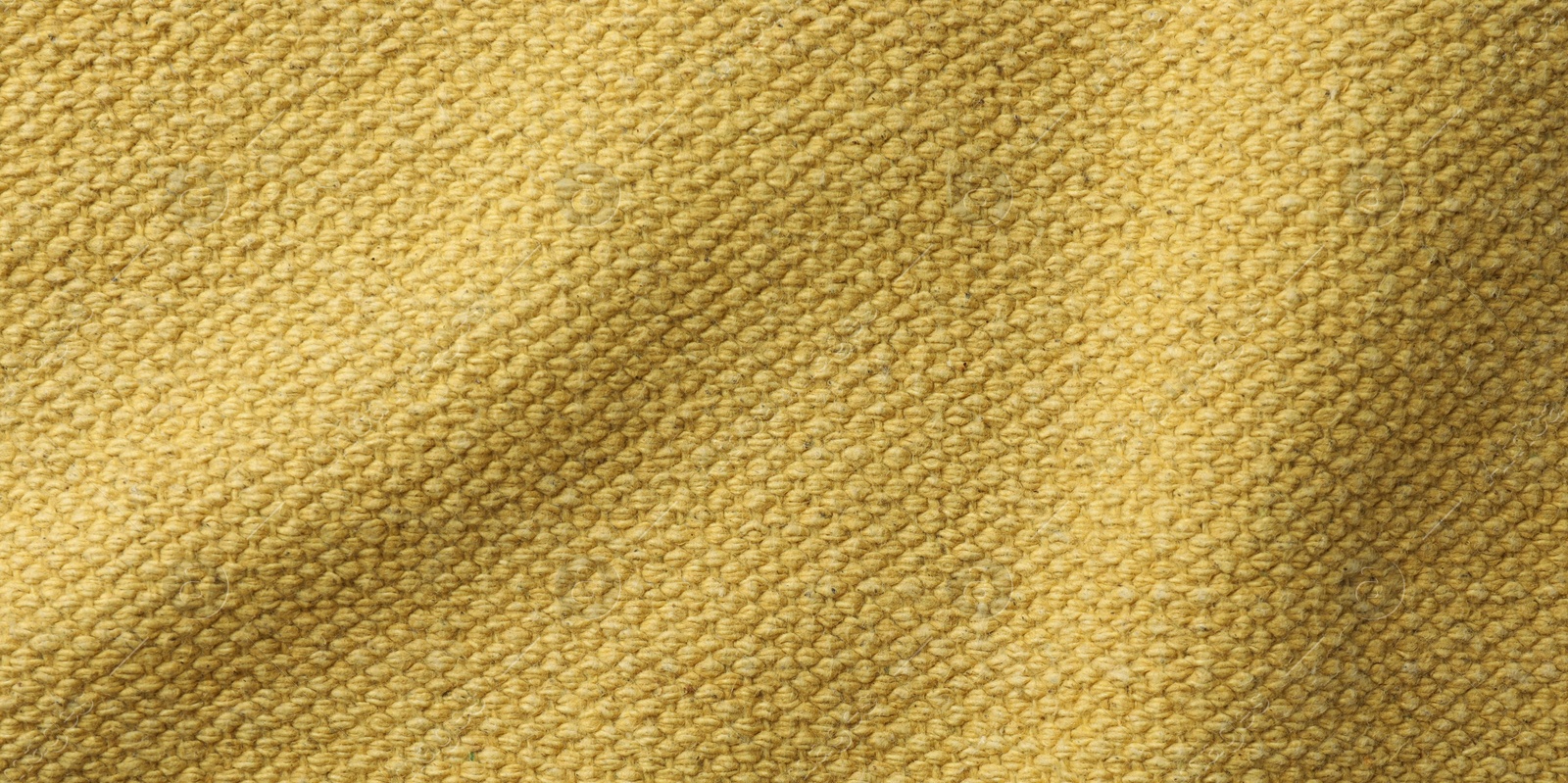 Photo of Texture of golden color fabric as background, top view