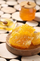 Natural honeycombs with honey on textured table, closeup. Space for text