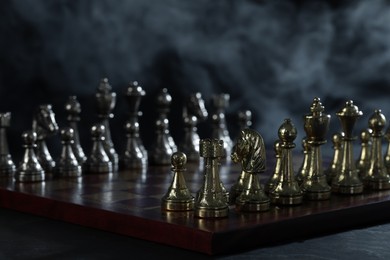 Photo of Set of chess pieces on checkerboard before game, selective focus
