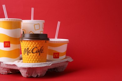 Photo of MYKOLAIV, UKRAINE - AUGUST 12, 2021: Cold and hot McDonald's drinks on red background