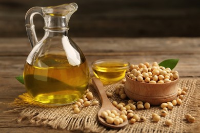 Photo of Composition with soybean oil on wooden table, closeup
