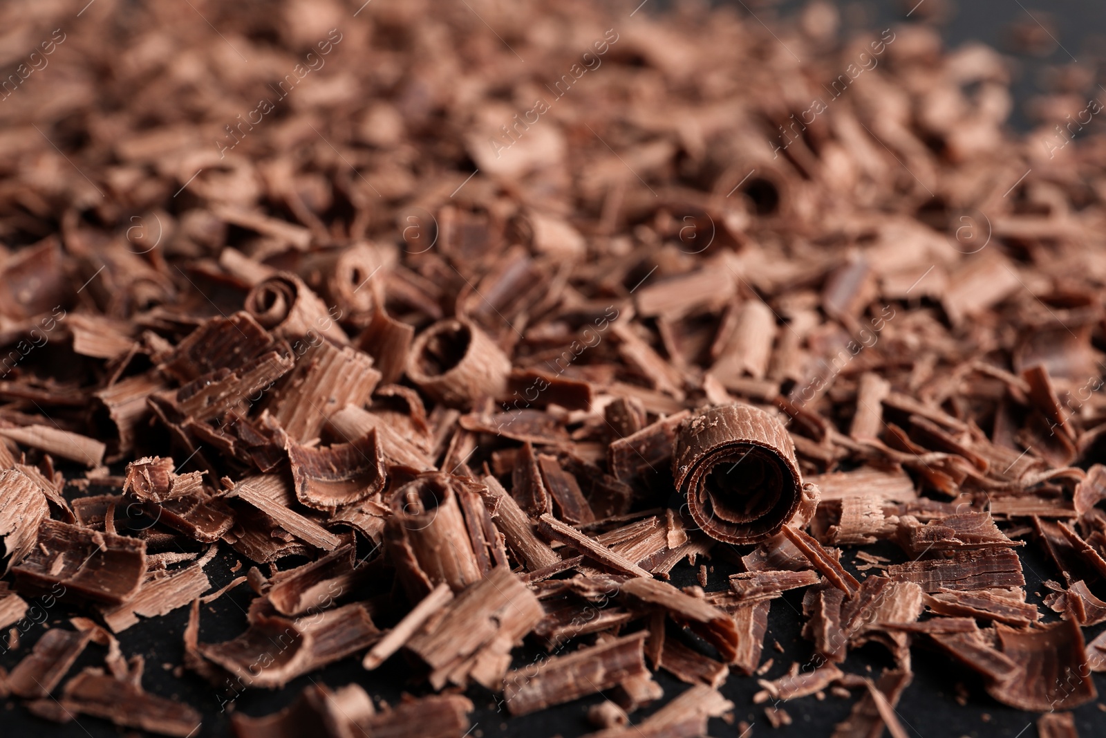 Photo of Pile of tasty chocolate curls as background