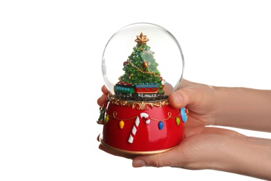 Woman holding beautiful snow globe on white background, closeup