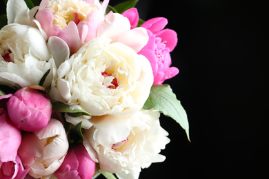 Photo of Bouquet of beautiful peonies on black background, closeup