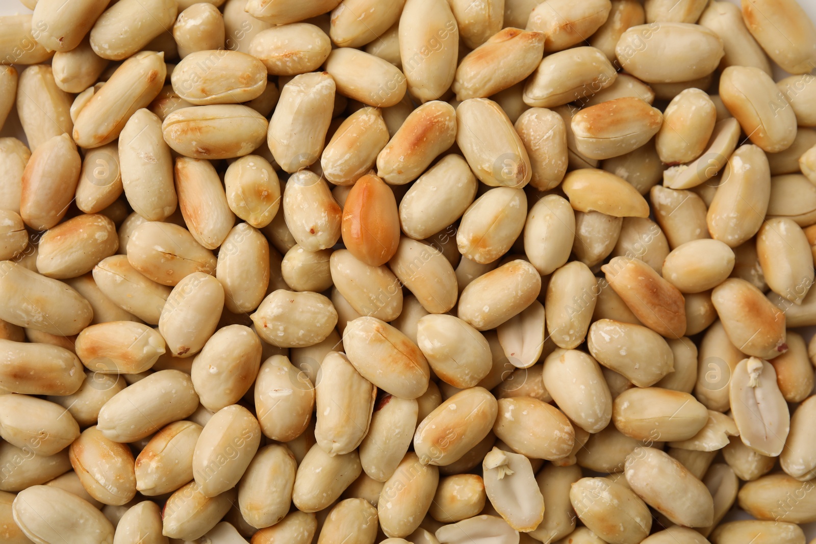 Photo of Many roasted peanuts as background, top view