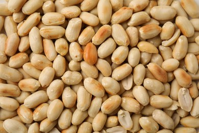 Many roasted peanuts as background, top view