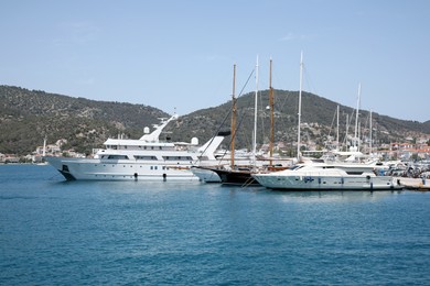 Photo of Beautiful view of different boats in sea near shore on sunny day