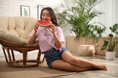 Photo of Beautiful young woman with watermelon at home