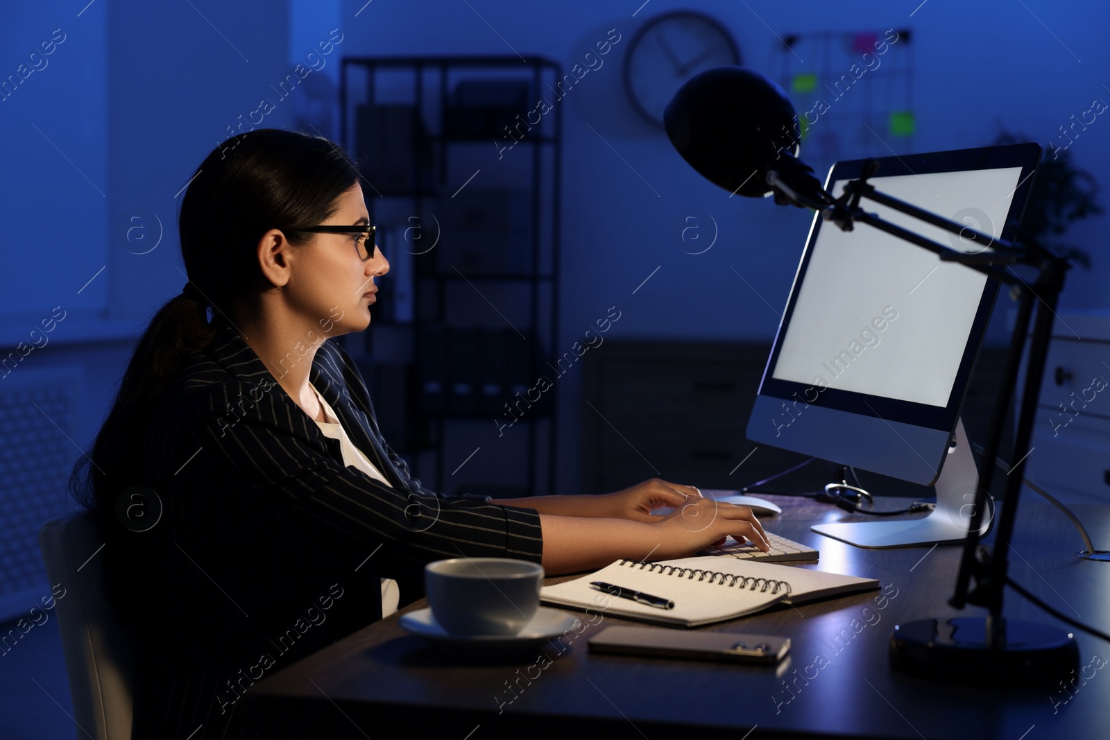 Photo of Tired businesswoman working at night in office