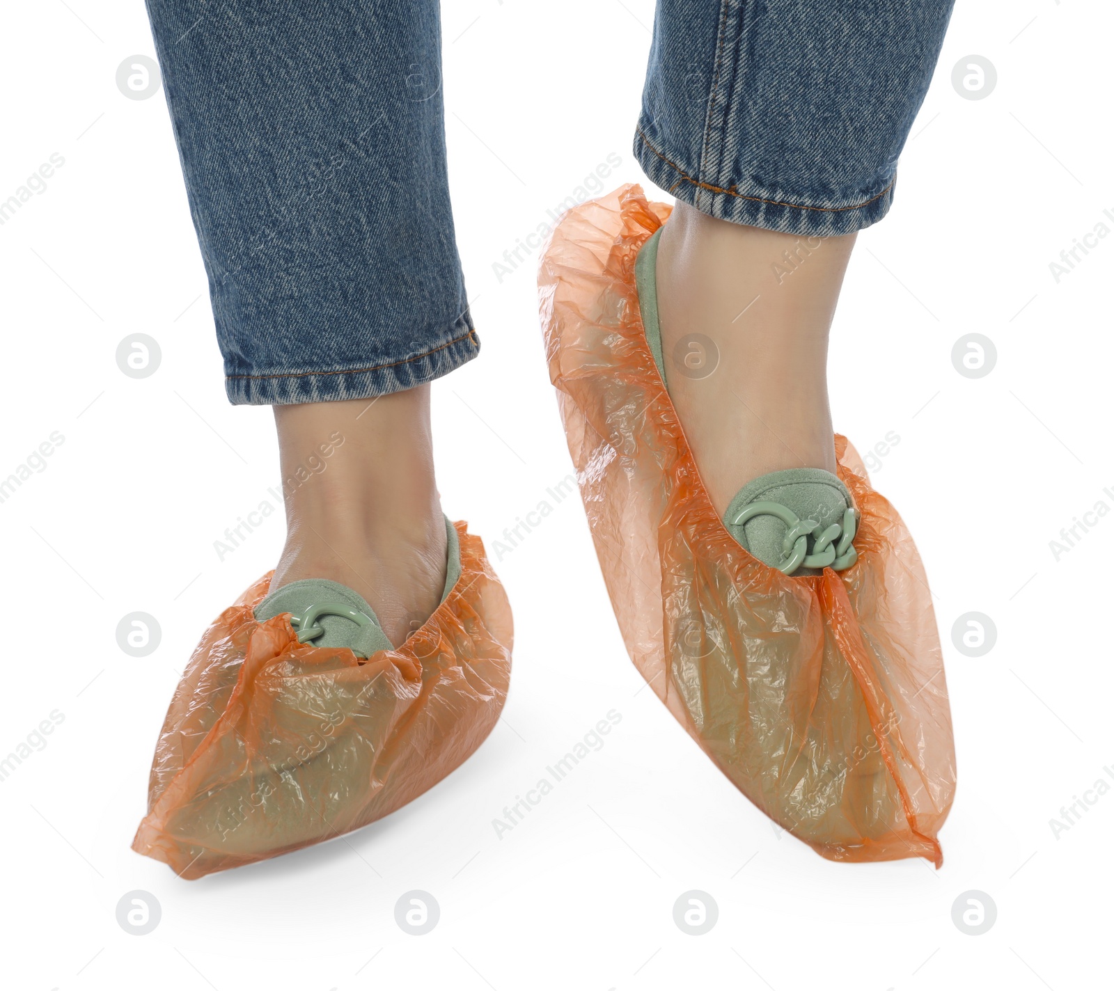 Photo of Woman wearing shoe covers onto her mules against white background, closeup