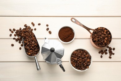 Photo of Coffee maker, beans and powder on white wooden table, flat lay