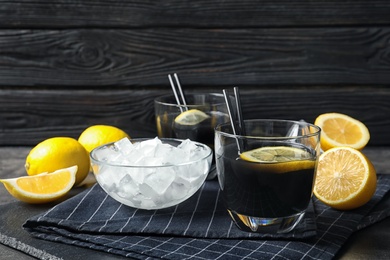Photo of Glasses with natural black lemonade on table