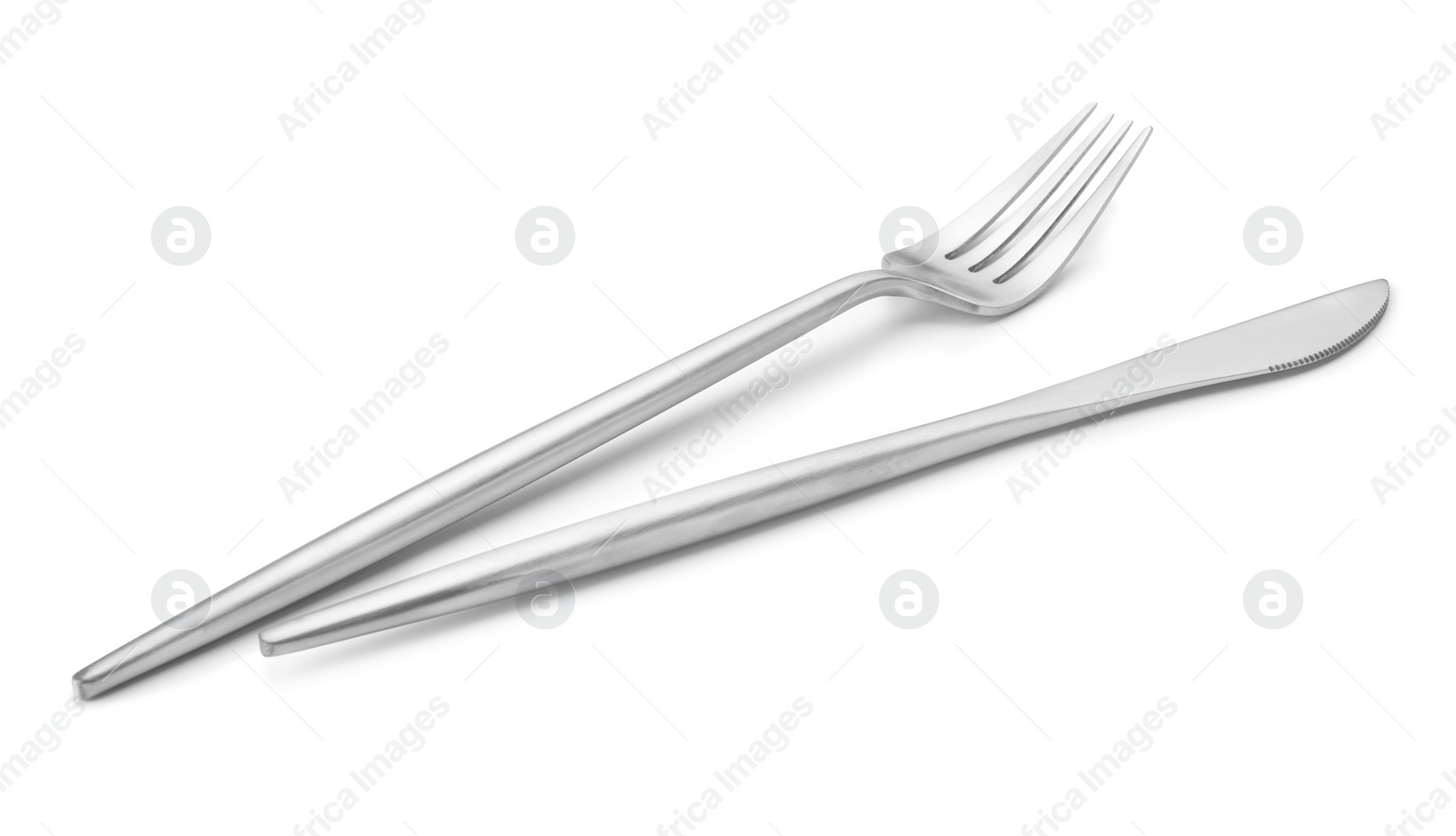 Photo of Shiny silver fork and knife isolated on white. Luxury cutlery