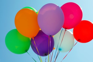 Photo of Bunch of colorful balloons against blue sky