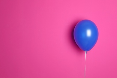 Blue balloon on color background. Celebration time