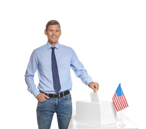 Photo of Man putting ballot paper into box against white background