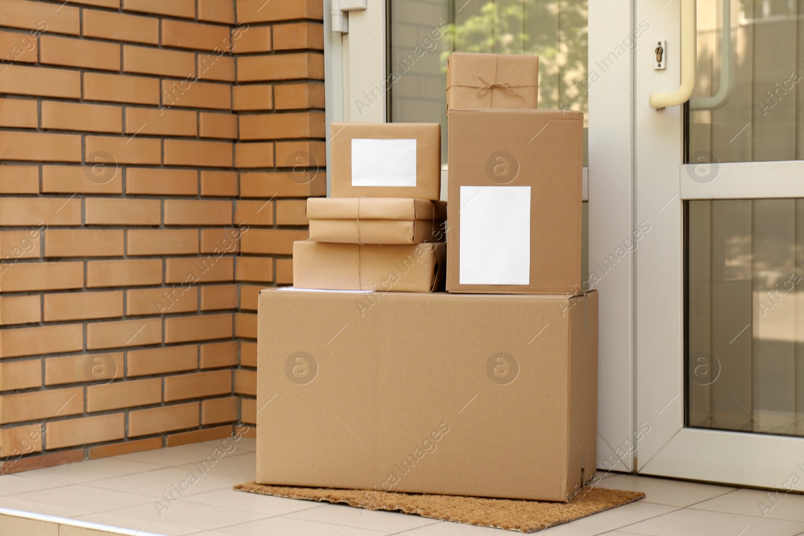 Photo of Delivered parcels on door mat near entrance